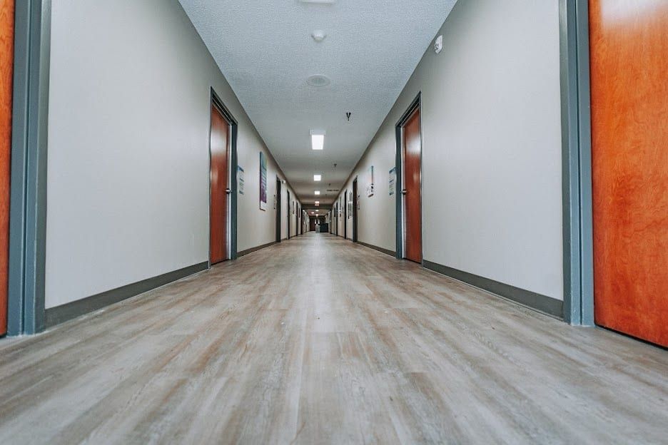 A resident hallway at Hickory Grove Recovery in Morrilton, lined with wooden doors