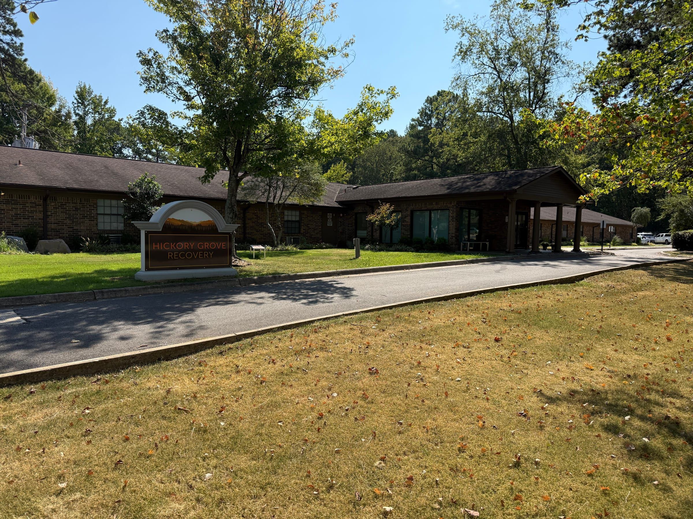 The Hickory Grove Recovery sign and the brick building behind it at 12 Hospital Drive in Morrilton, Arkansas