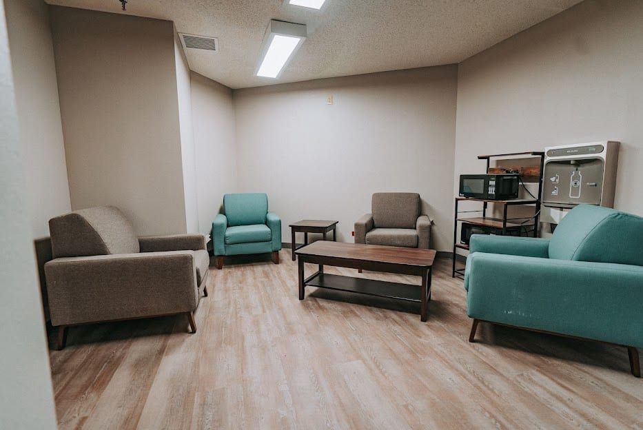A quiet lounge at Hickory Grove Recovery in Morrilton with armchairs around a coffee table