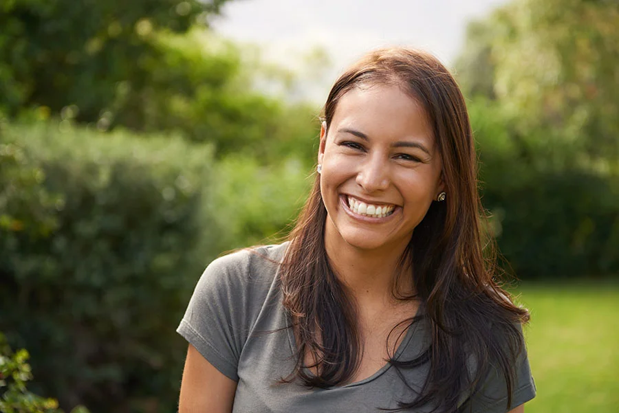 a smiling woman faces the camera