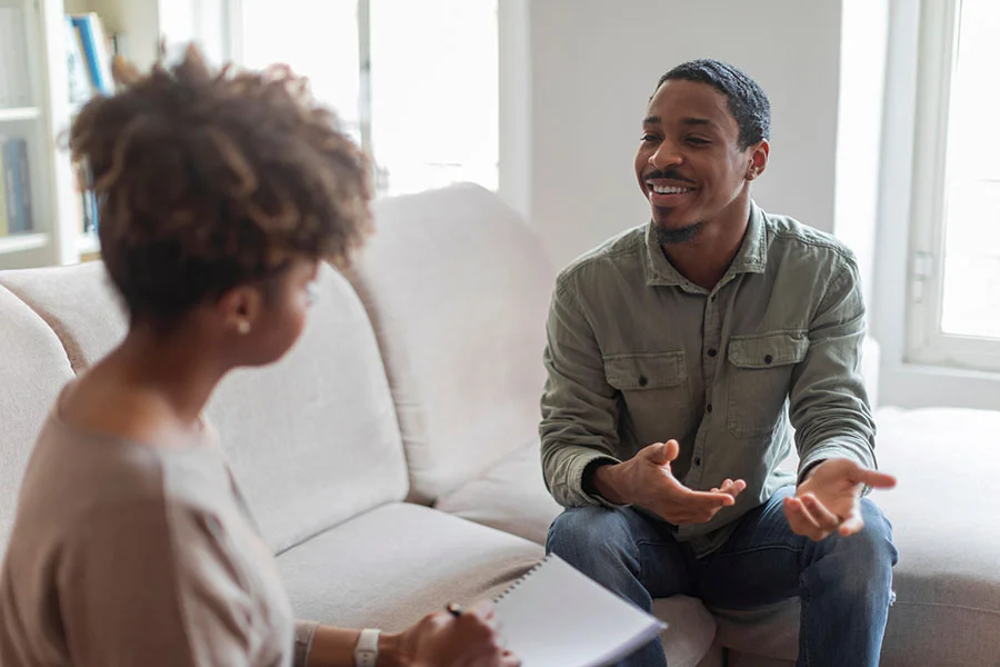 a man opens up to a counselor in a therapy program